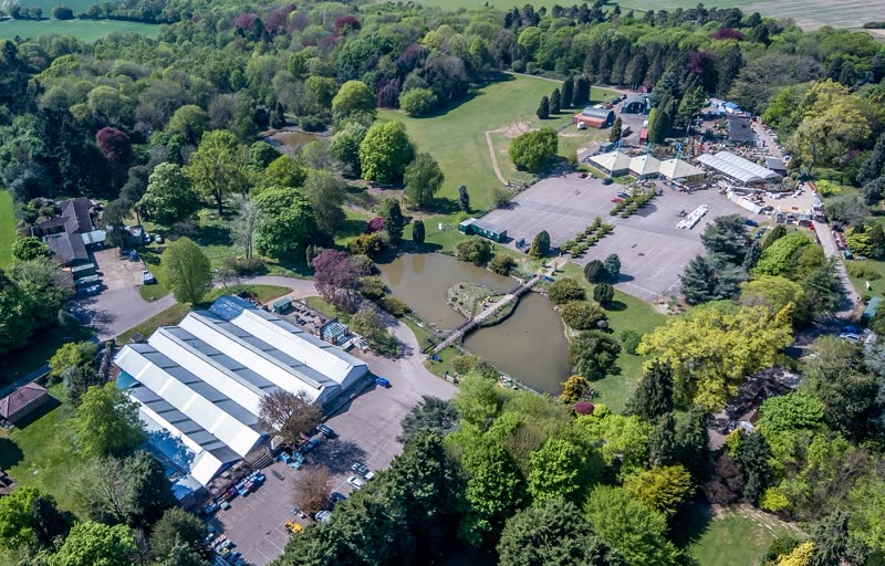 Aerial view of the garden centre with its glasshouses, car park, pond and surrounding woodland